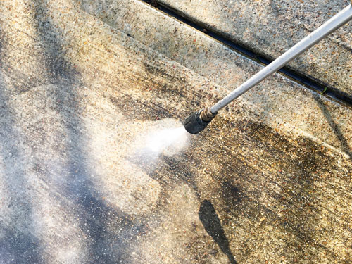 Keep your hardscaping clean by power washing walkways and driveways.